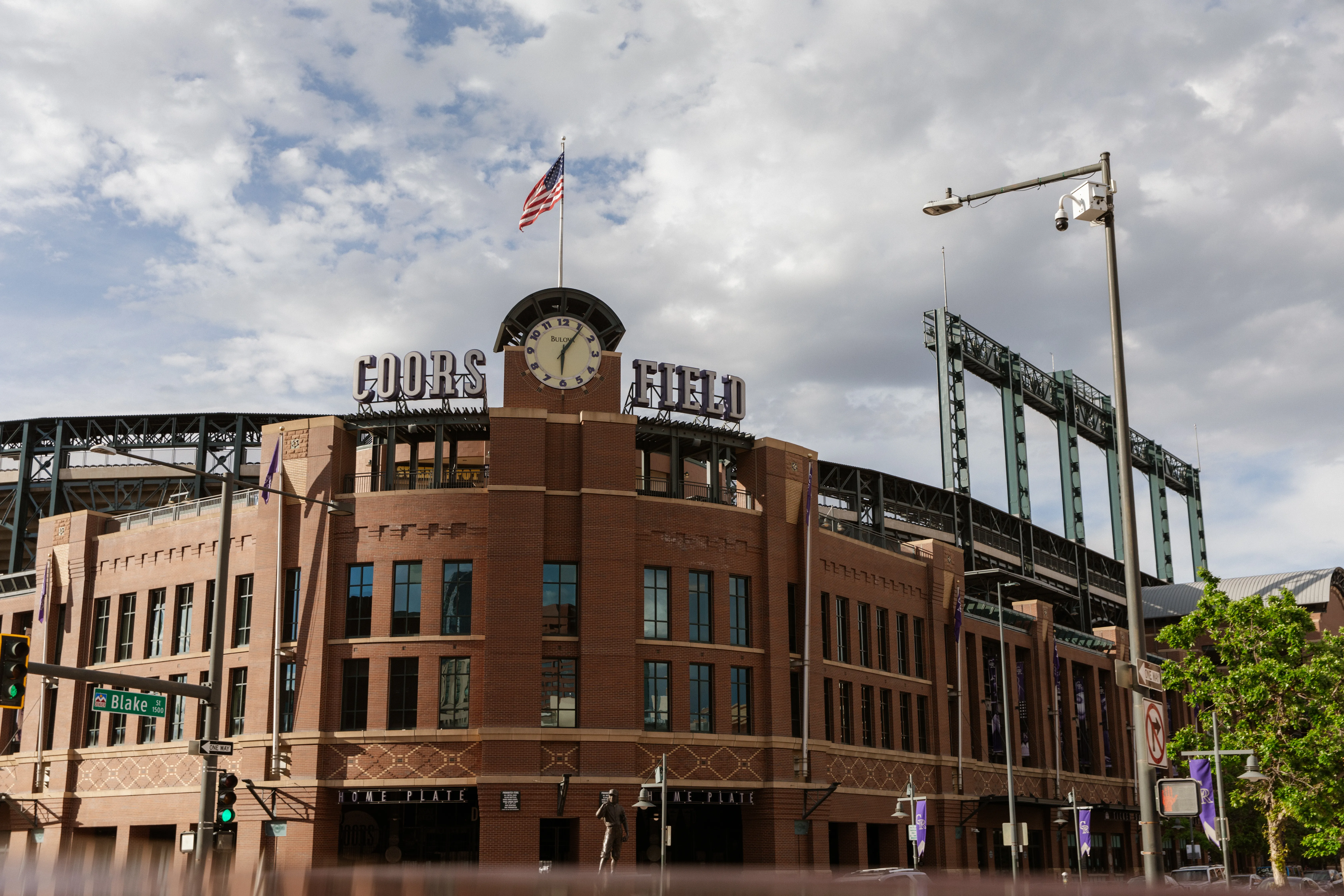 Coors Field clock tower under broken clouds