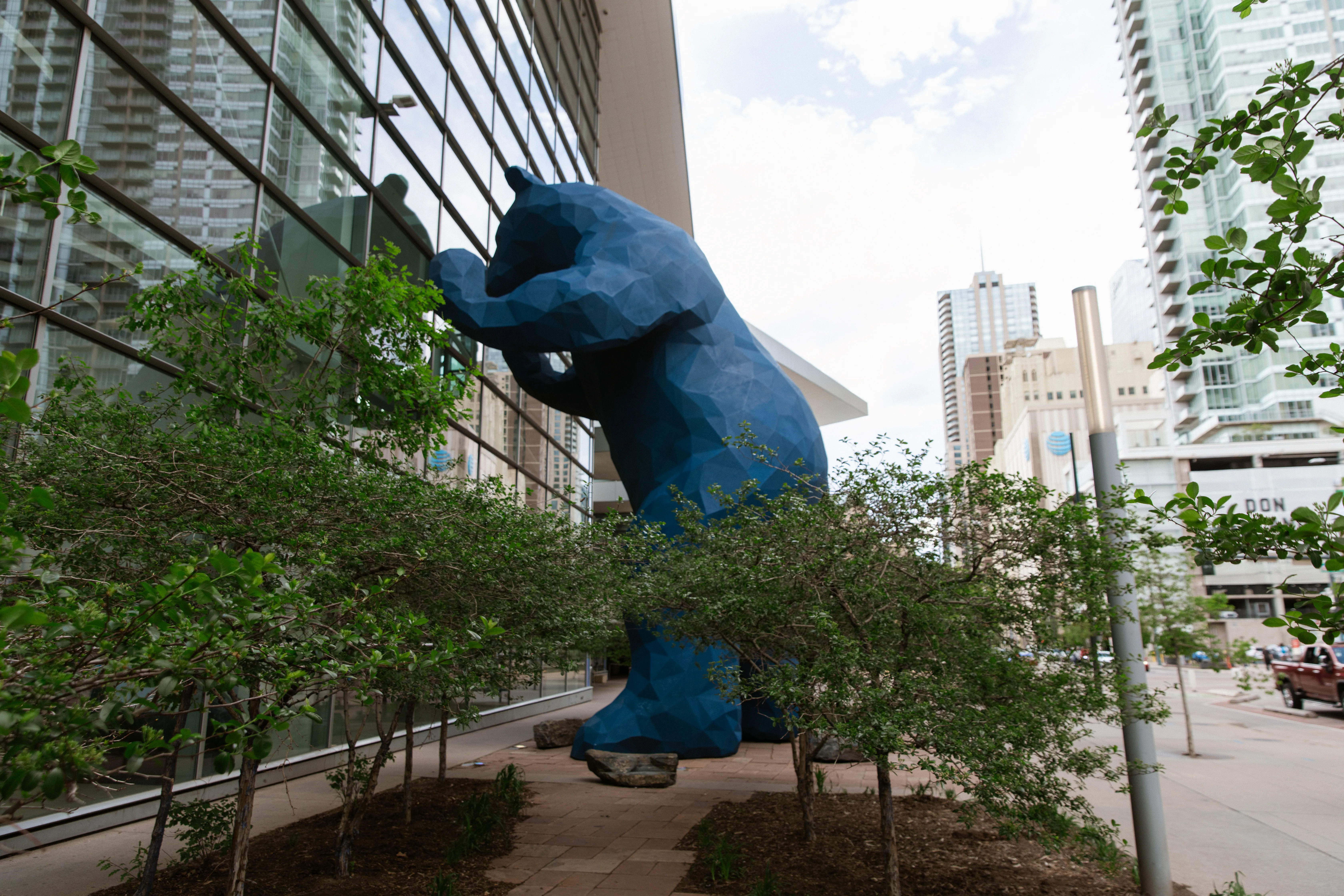 Blue Bear with downtown towers behind it
